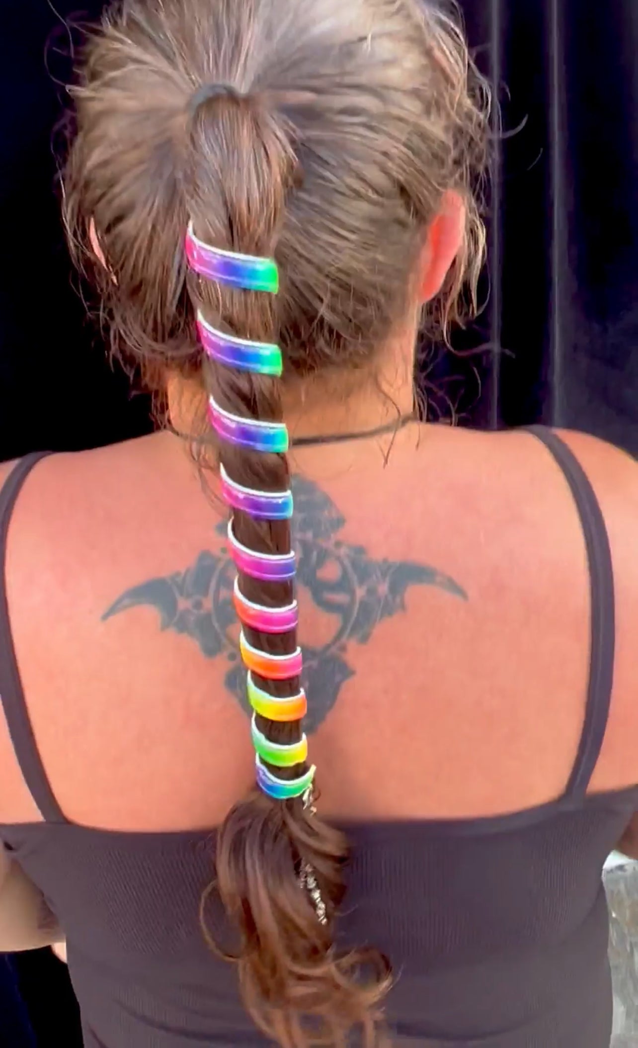 Model wearing Ponytail Wrap - 12" Unicorn Rainbow Leather Vibrant Hair Accessory